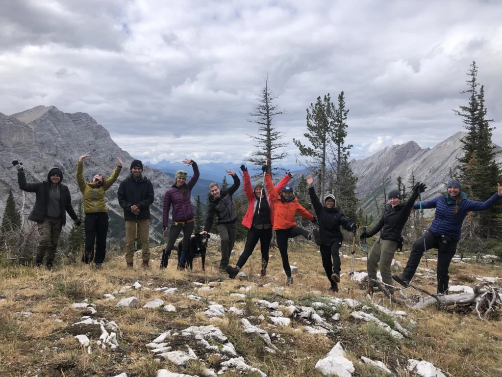 A group posing on top of a mountain