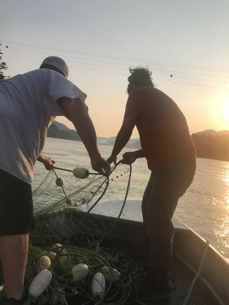 Two mans doing small-scale fishing in Wuikinuxv Territory