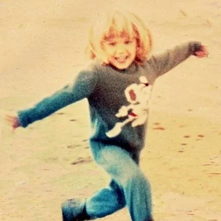 Alex as a child on the beach in Scarborough, England