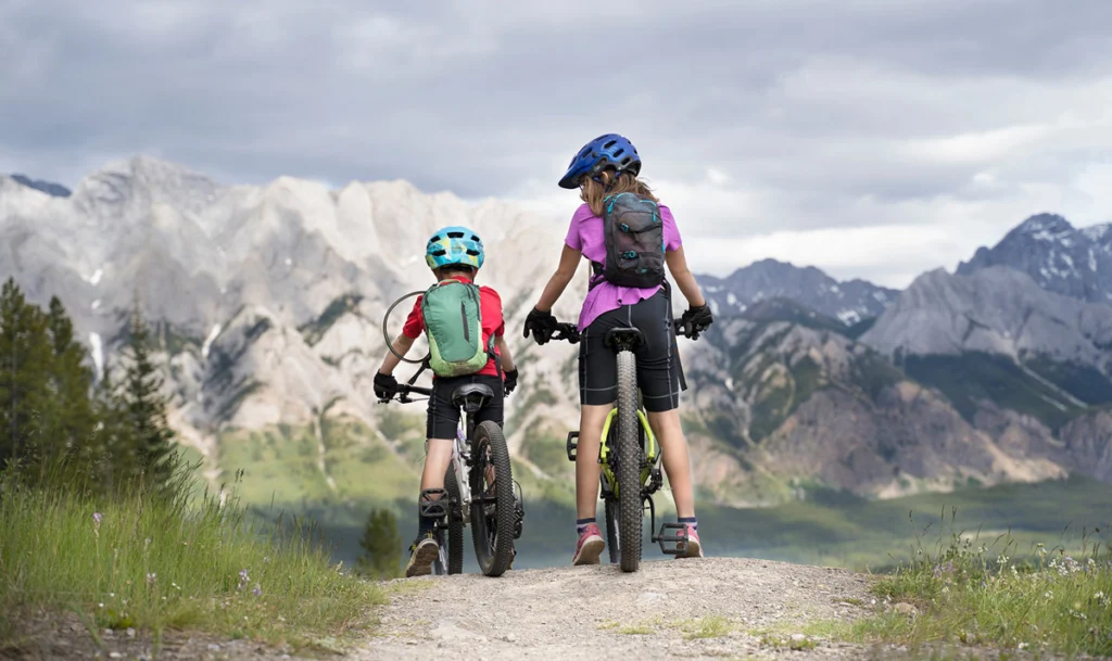 A big sister and her little-brother on a family mountain bike ride in Kananaskisé, Albert