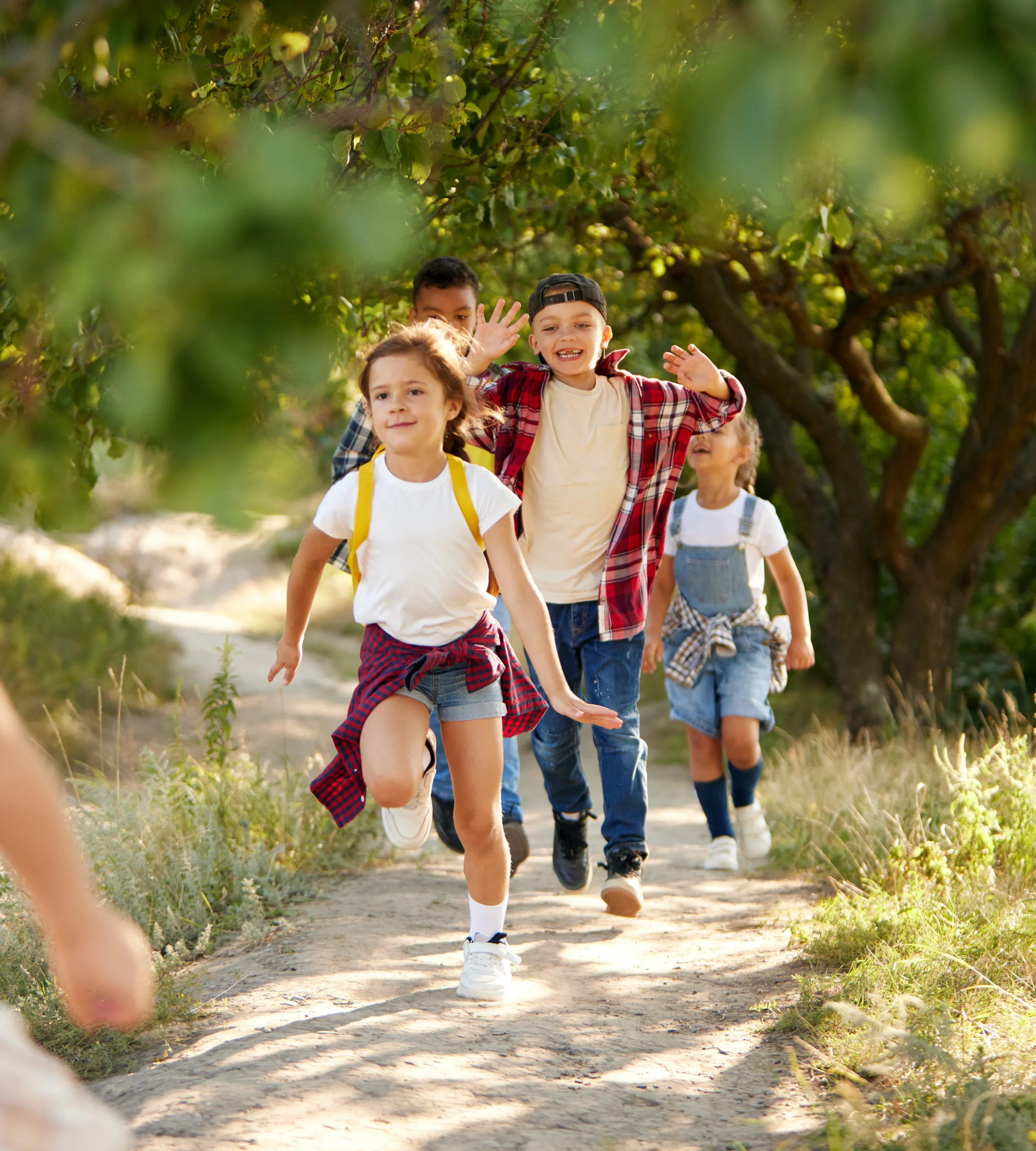 Group of children running along a trail.